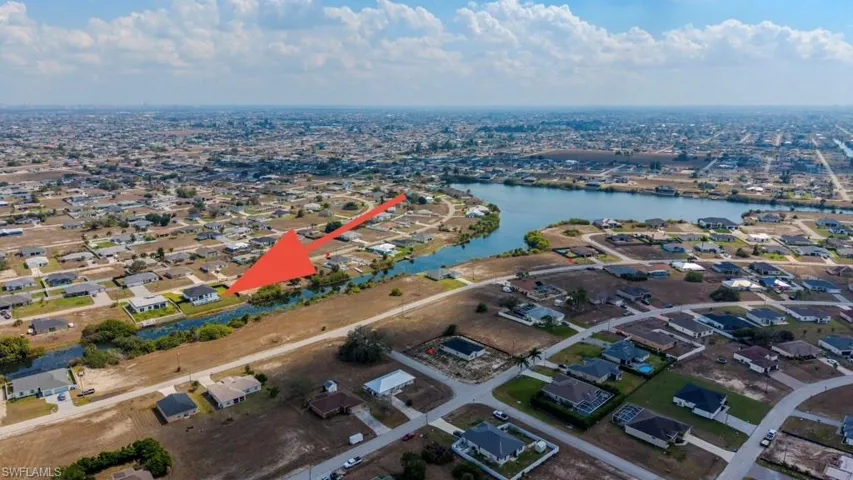 Aerial overview of property's location featuring nearby suburban area and a large body of water