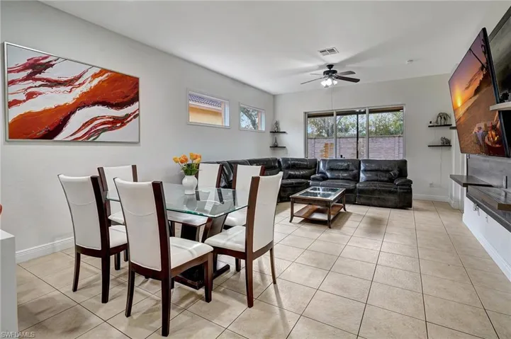 Dining area with ceiling fan and light tile patterned floors