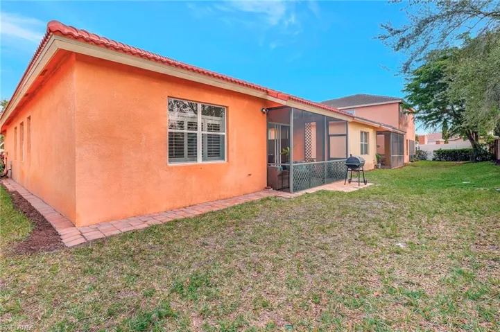 Rear view of house with a yard