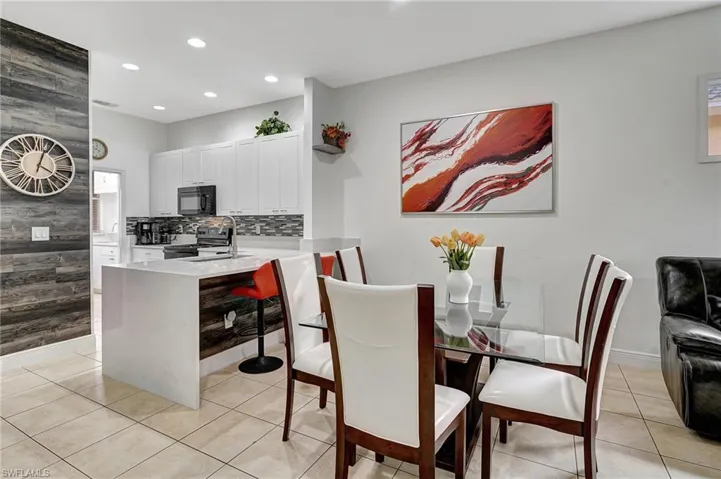 Dining room with sink and light tile patterned flooring