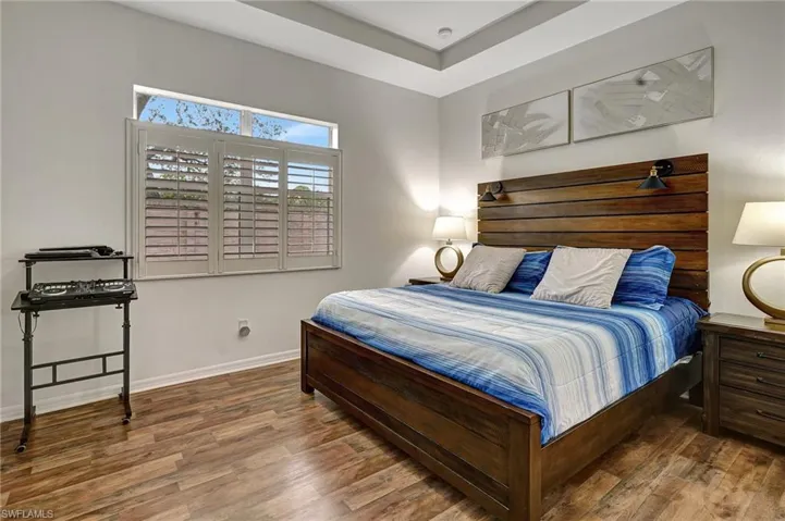 Bedroom with dark wood-type flooring
