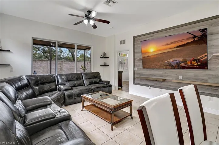 Tiled living room featuring ceiling fan