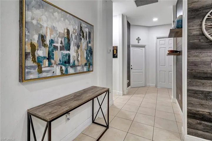 Hall with light tile patterned floors