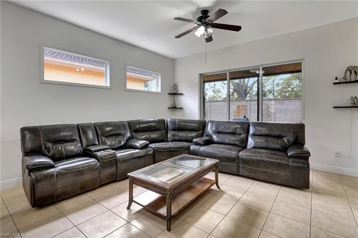 Living room featuring ceiling fan and light tile patterned floors