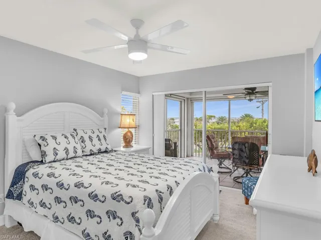Bedroom featuring ceiling fan, access to exterior, and light carpet