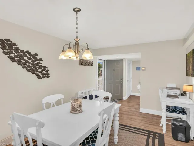 Dining room featuring hardwood / wood-style flooring and an inviting chandelier