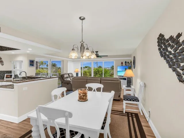 Dining space with a chandelier, light hardwood / wood-style flooring, and a wealth of natural light