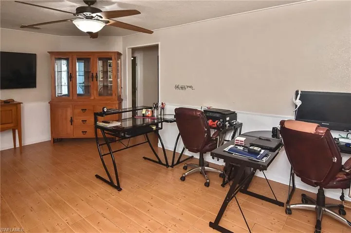 Office area with light hardwood / wood-style flooring and ceiling fan