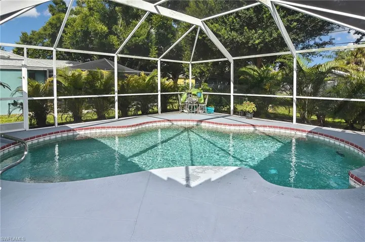 View of swimming pool featuring a patio and glass enclosure