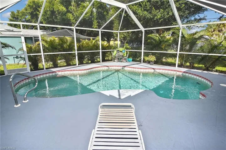 View of pool with a patio area and a lanai