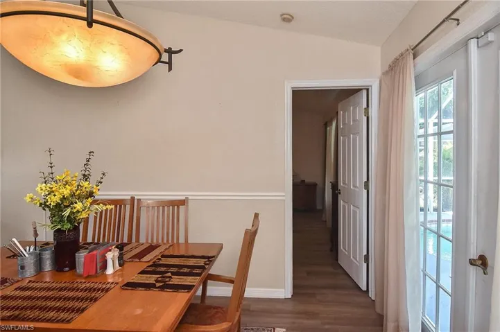 Dining area featuring lofted ceiling and hardwood / wood-style floors