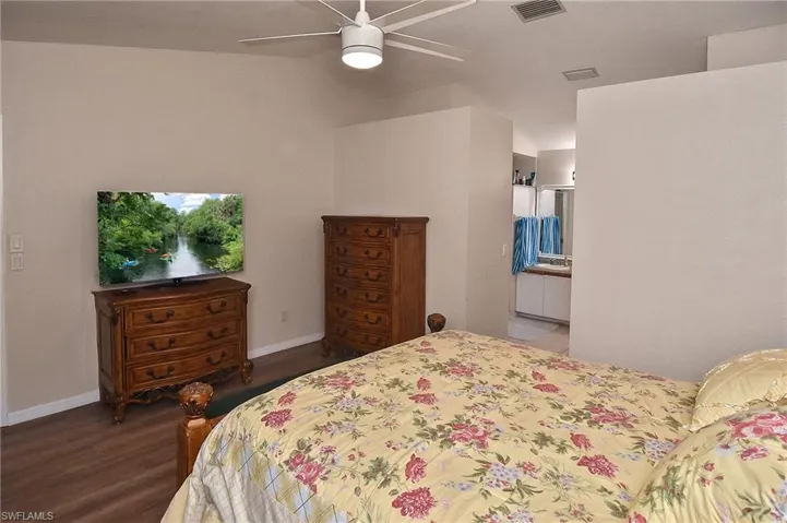 Bedroom featuring ceiling fan and hardwood / wood-style flooring