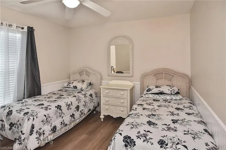 Bedroom featuring dark hardwood / wood-style floors and ceiling fan