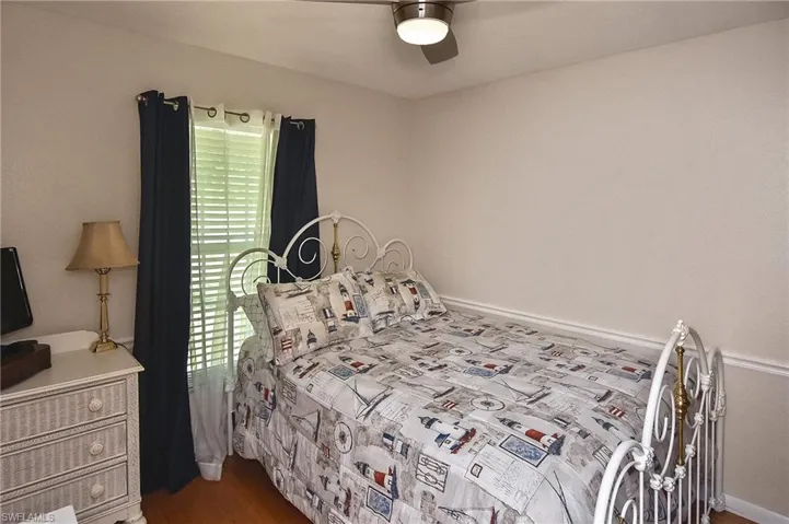 Bedroom featuring ceiling fan and hardwood / wood-style flooring