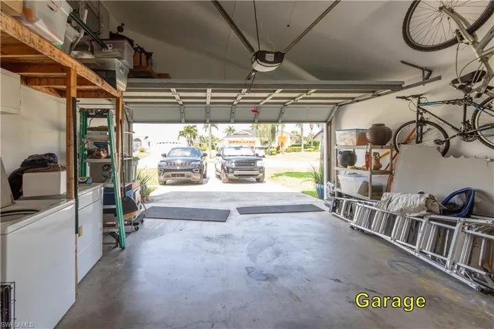 Garage with washing machine and dryer and a garage door opener