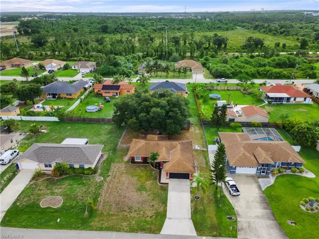 Aerial view of residential area featuring a heavily wooded area