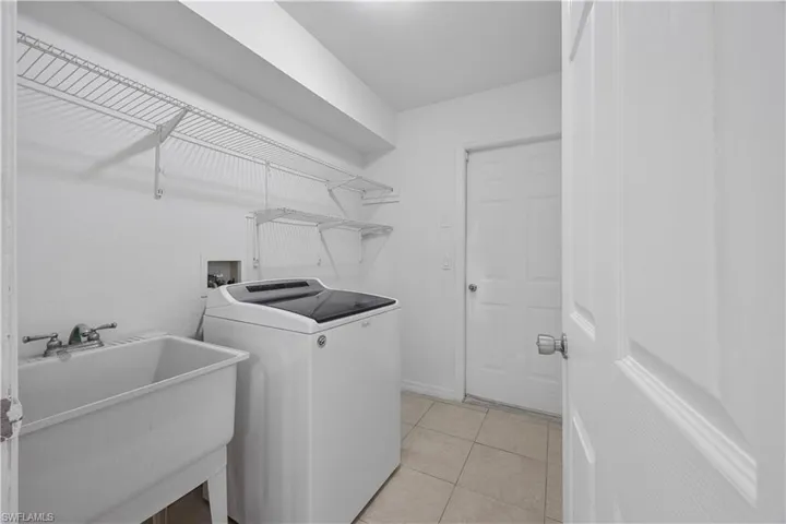 Laundry room featuring washer / dryer and light tile patterned floors