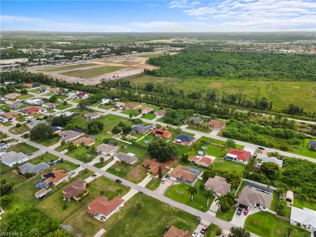 Aerial overview of property's location with nearby suburban area