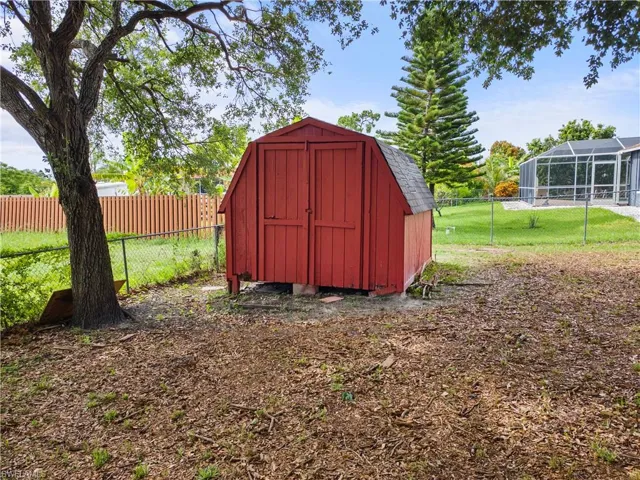 View of shed with a fenced backyard
