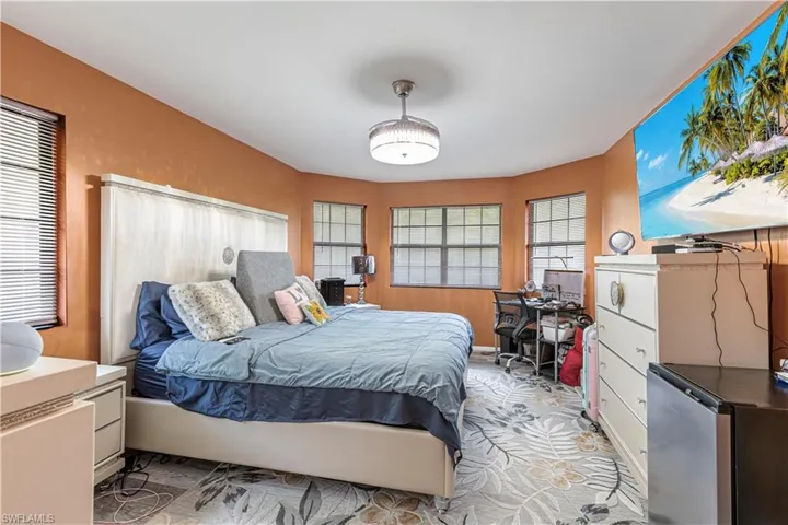 Bedroom featuring stainless steel fridge