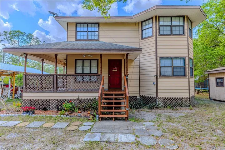 View of front of house featuring ceiling fan and covered porch
