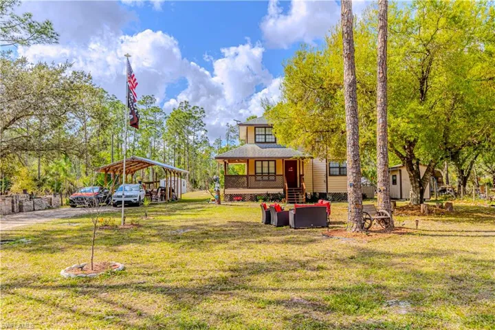 View of yard featuring a porch and a carport