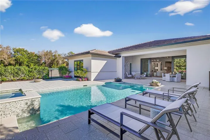 Swimming pool and spa with  large patio area with plenty of lounging space plus an outdoor fire pit