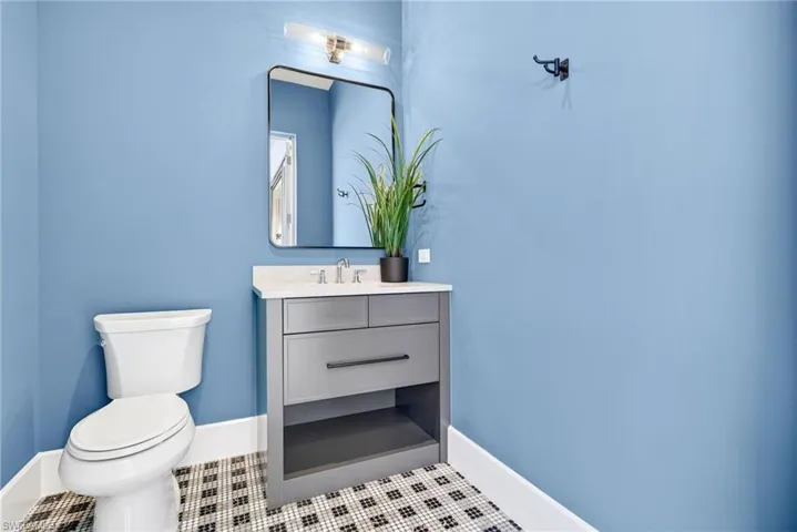 Pool bath featuring a simple vanity and a stylish tile patterned flooring