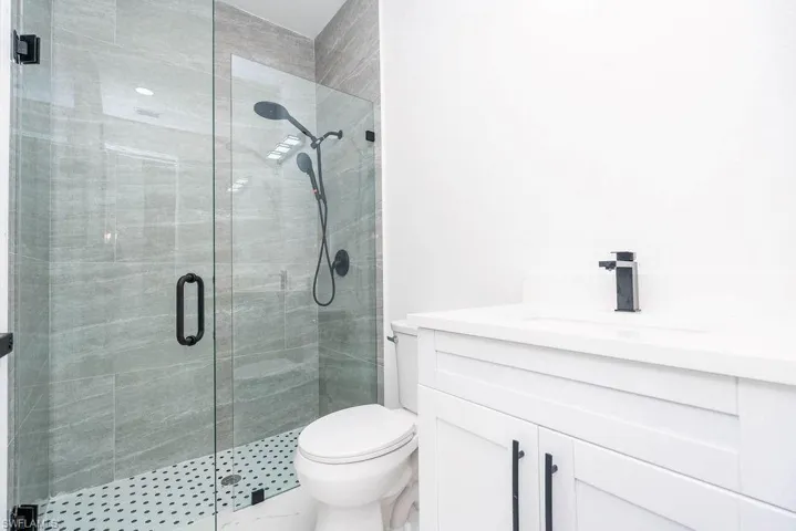 Bathroom featuring vanity and a shower stall
