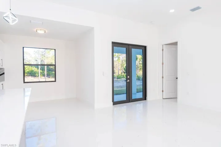 Unfurnished room with french doors and light marble finish floors