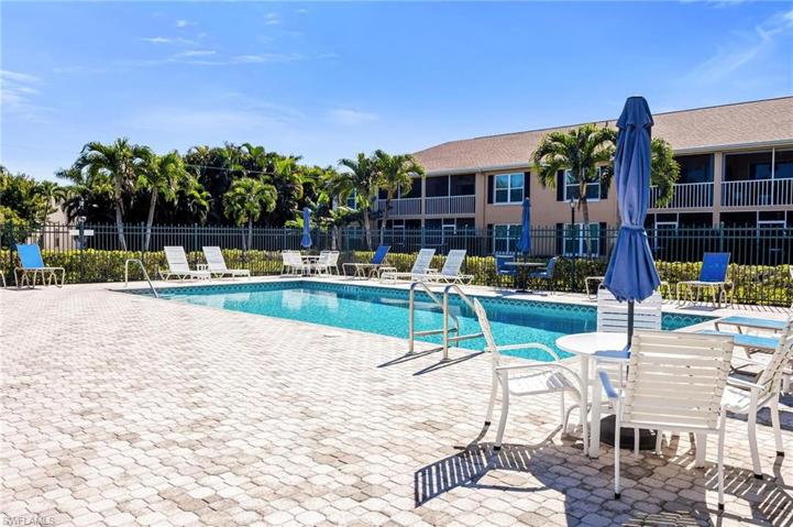 Community pool with pavers and grills and restrooms.