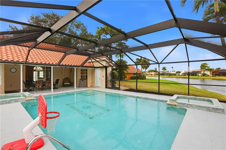 View of swimming pool featuring a pool with connected hot tub, a patio, a lanai, and a sunroom