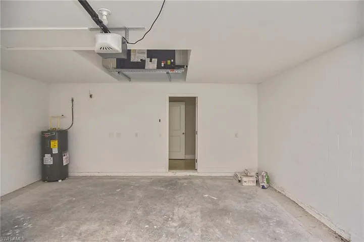 Garage with electric water heater and a garage door opener