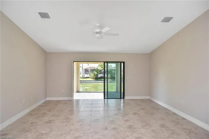 Spare room featuring ceiling fan and light tile patterned floors