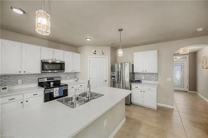 Granite countertops, backsplash & decorative lighting throughout