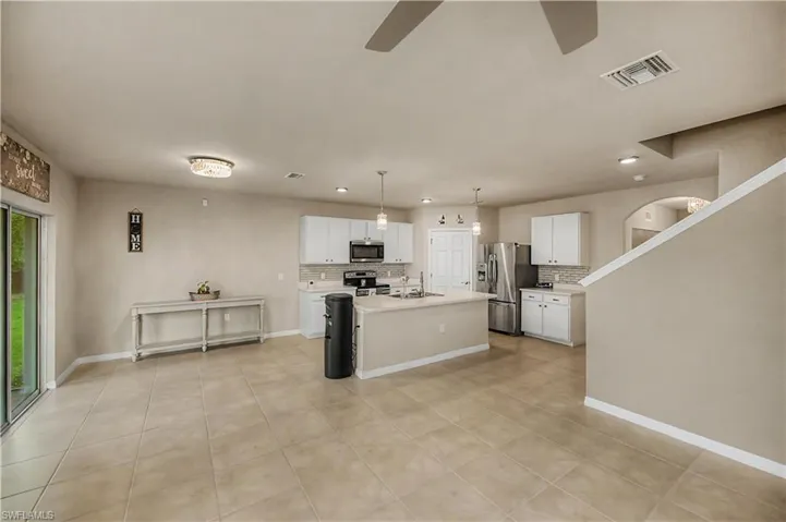 view of kitchen from living space and the staircase to 2nd floor.