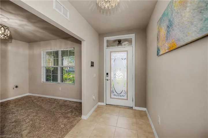 from inside the home looking at beveled glass front door and the den