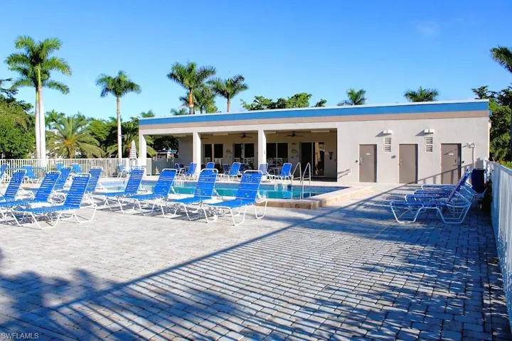 Community pool with a patio area and a ceiling fan