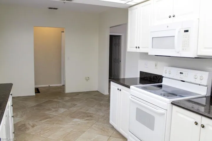Kitchen with white appliances and white cabinets