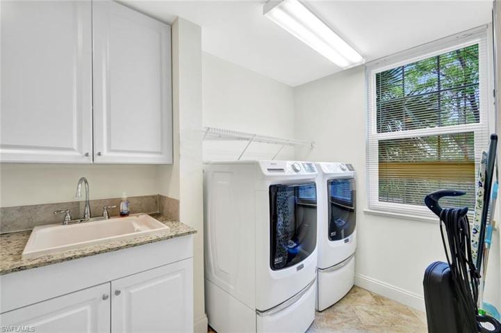 Large Laundry room with Cabinets and Newer Washer and Dryer