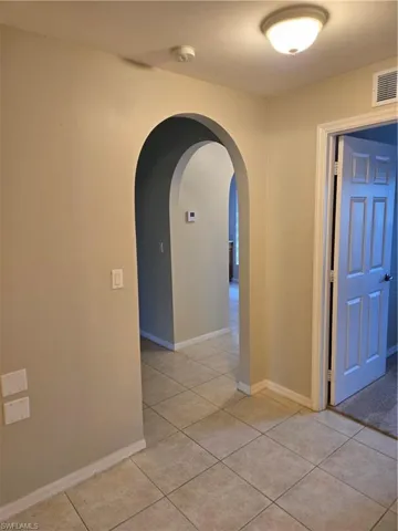 Hall featuring light tile patterned floors