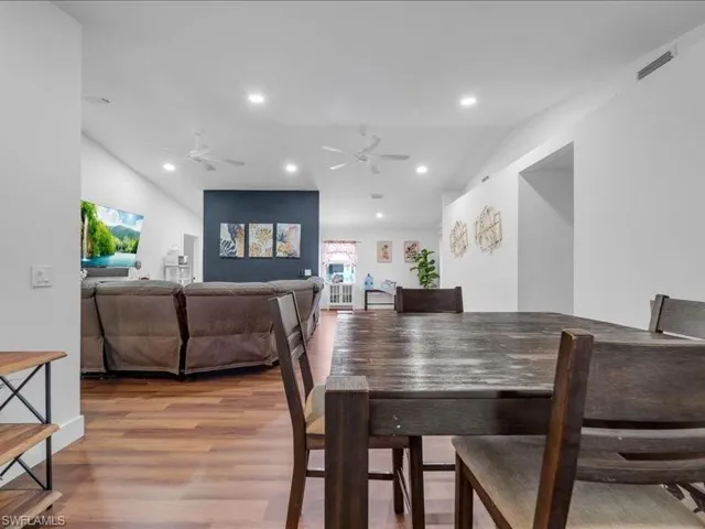 Spacious interior featuring wood-finish flooring, recessed lighting, and multiple ceiling fans