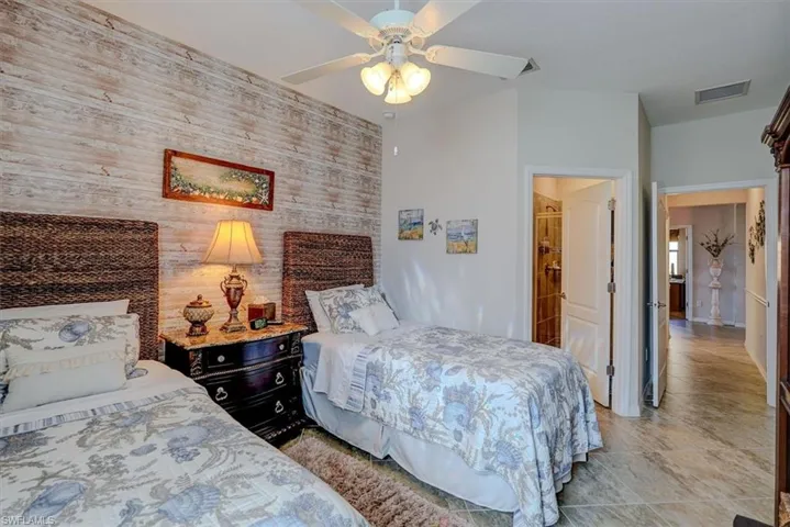 Bedroom with ceiling fan and wooden walls