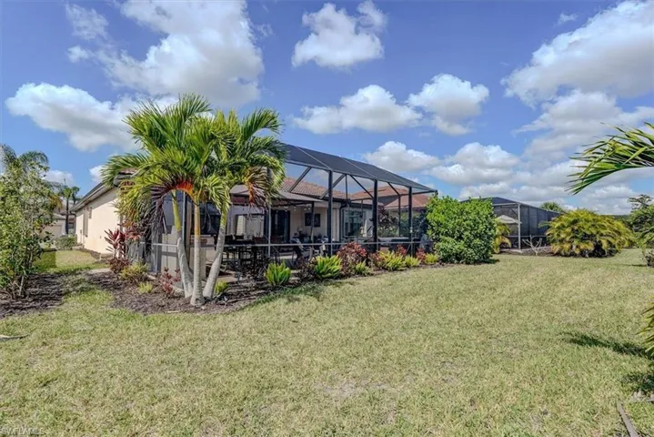 View of yard featuring glass enclosure