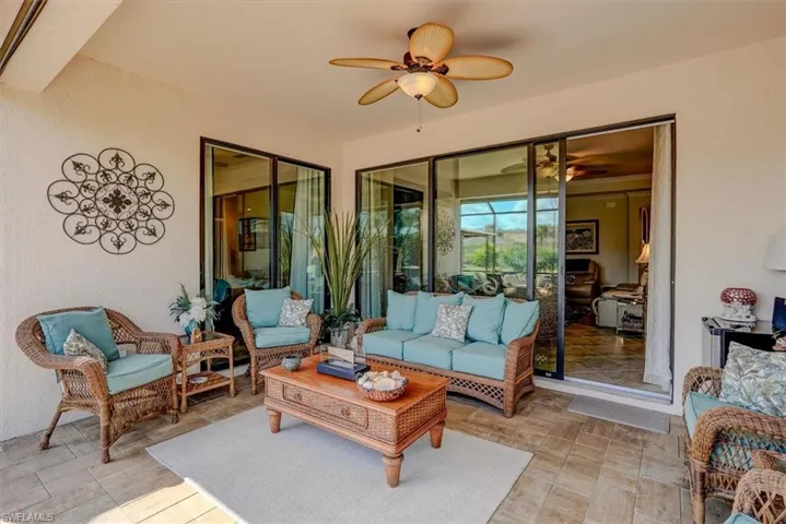 Sunroom / solarium featuring ceiling fan