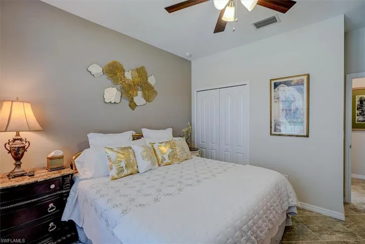 Bedroom featuring ceiling fan and a closet
