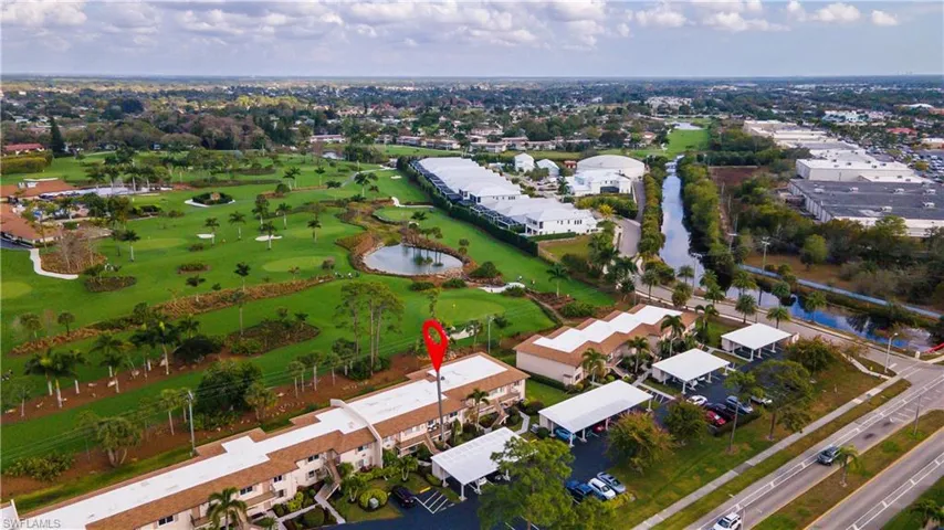 View of property location with a nearby body of water and a local golf course