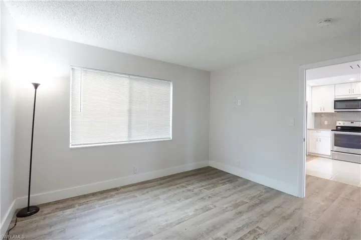 Spare room with a textured ceiling and light wood-style floors