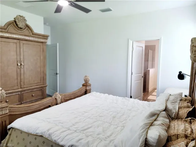 Bedroom with ceiling fan and ensuite bathroom