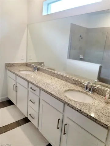 Bathroom featuring double vanity and walk in shower